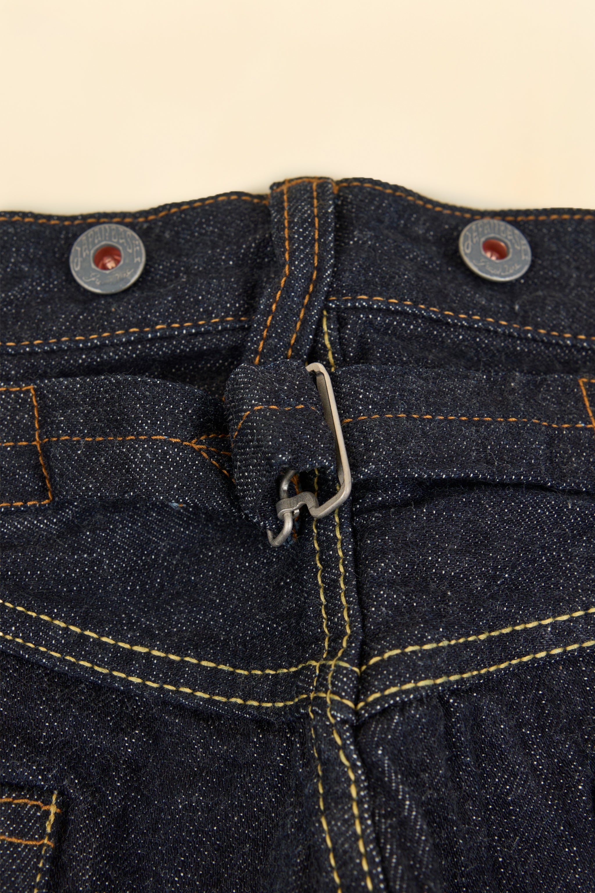 Graph Zero Heritage Denim - 13oz close-up of metal button fly and cinch-back closure.
