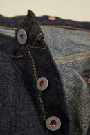 Graph Zero Heritage Denim - 13oz close-up of embossed metal buttons and selvedge denim fabric details.