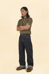 Model wearing Graph Zero Heritage Denim - 13oz styled with a casual olive green t-shirt and brown shoes.
